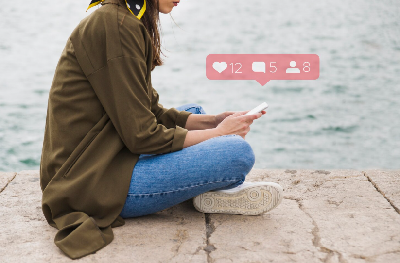 Creator checking social media feedback on their phone, navigating confidence to share work.