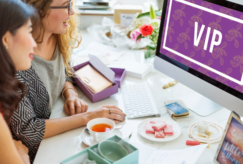 Supporters looking at a computer screen that says VIP, representing patrons receiving exclusive creator perks.